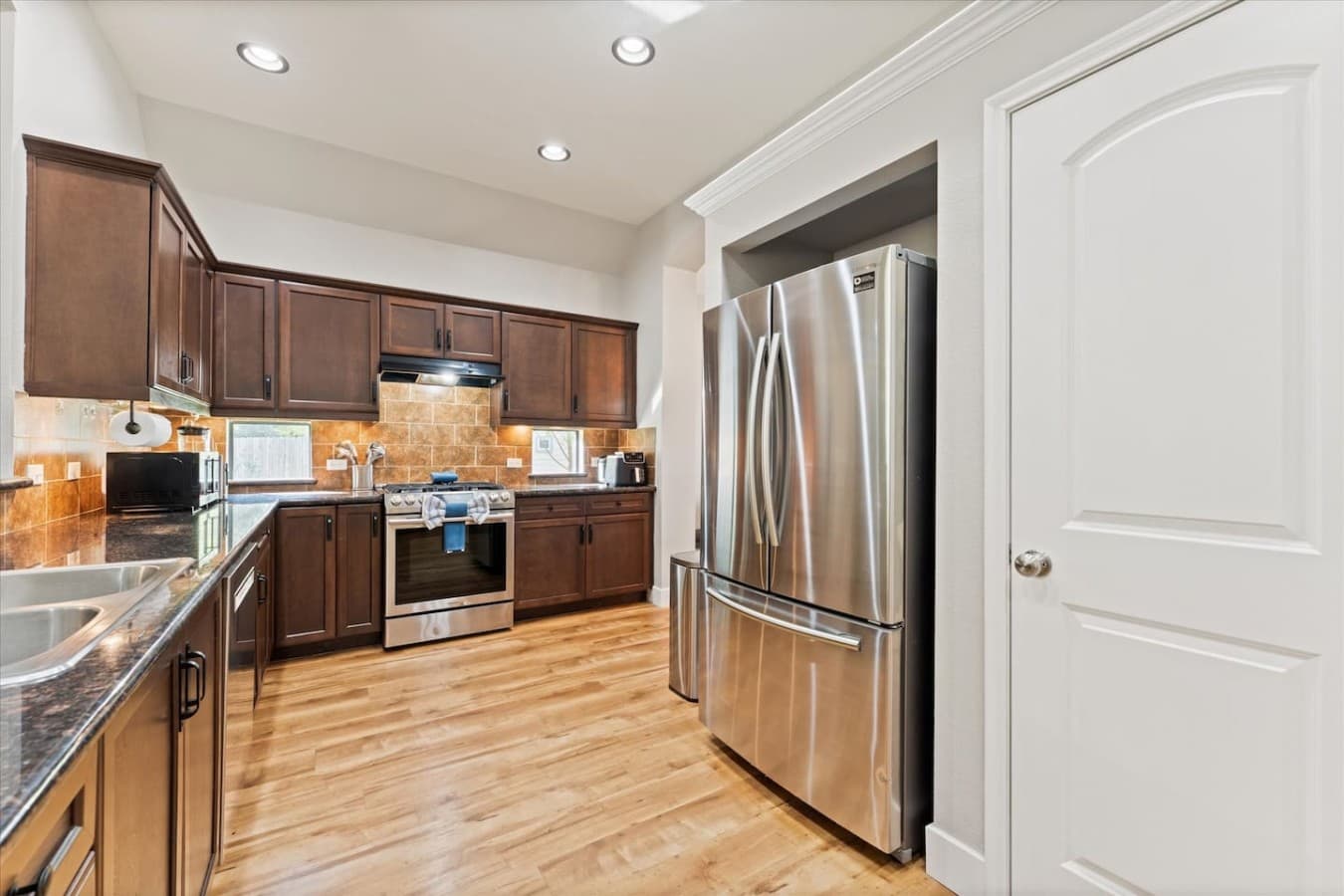 Fully equipped kitchen with stainless steel appliances and plenty of space to cook and gather.