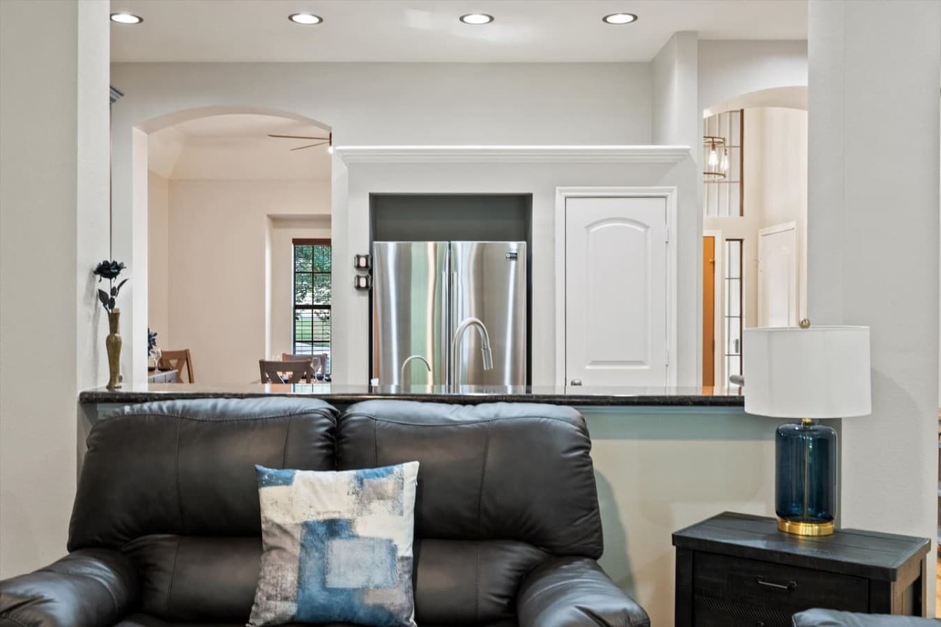Cozy living room seating with a convenient open view into the fully equipped kitchen.