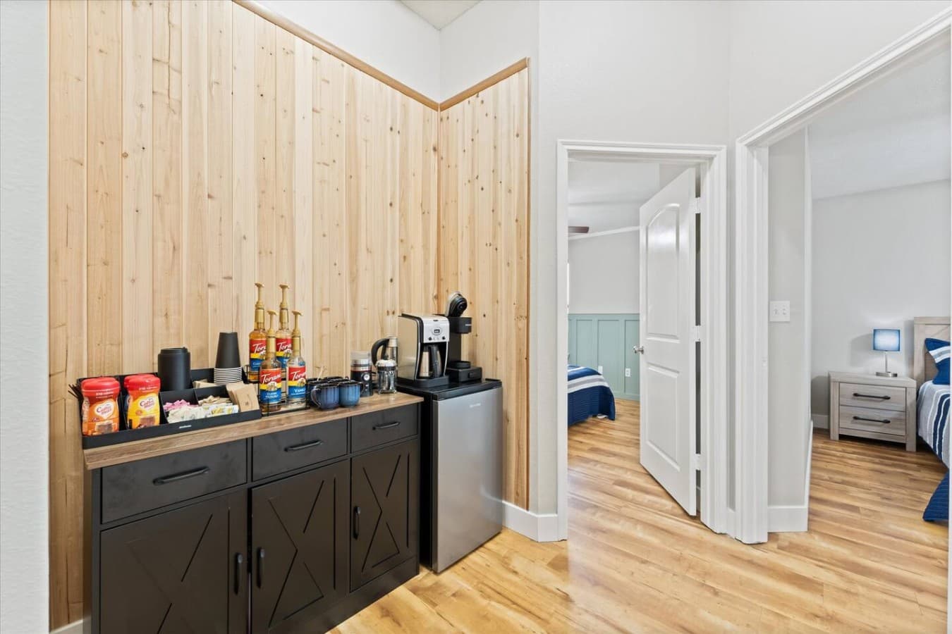 Convenient coffee and snack station with a mini fridge located just steps from the bedrooms.