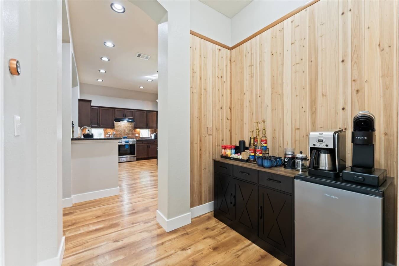 Convenient coffee and beverage station tucked just off the kitchen for easy mornings and late night drinks.