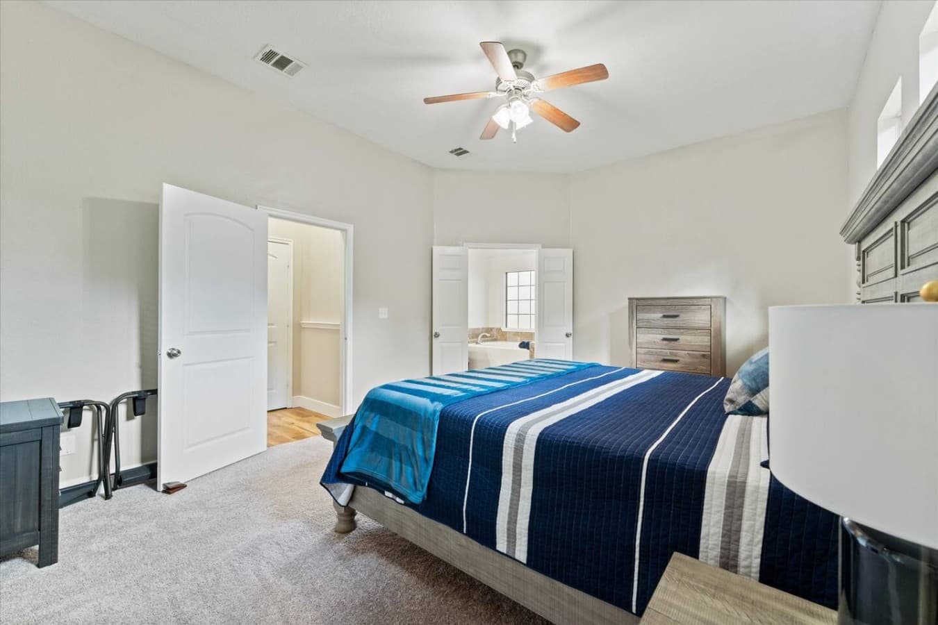 Comfortable private bedroom with cozy furnishings and convenient access to the en suite bathroom.