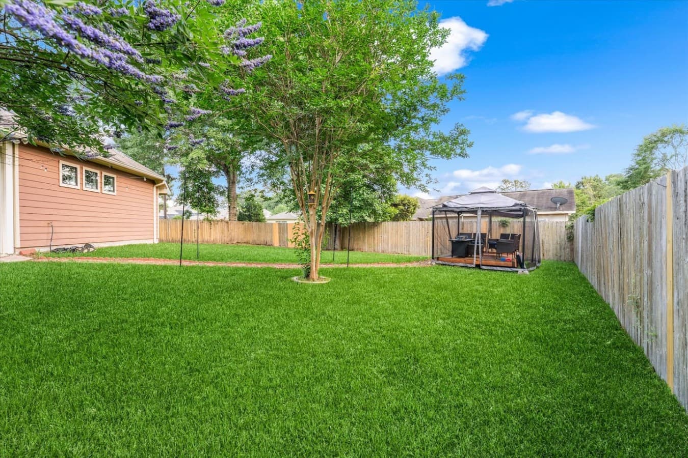 Beautiful open lawn with shaded trees and plenty of room to spread out and unwind.