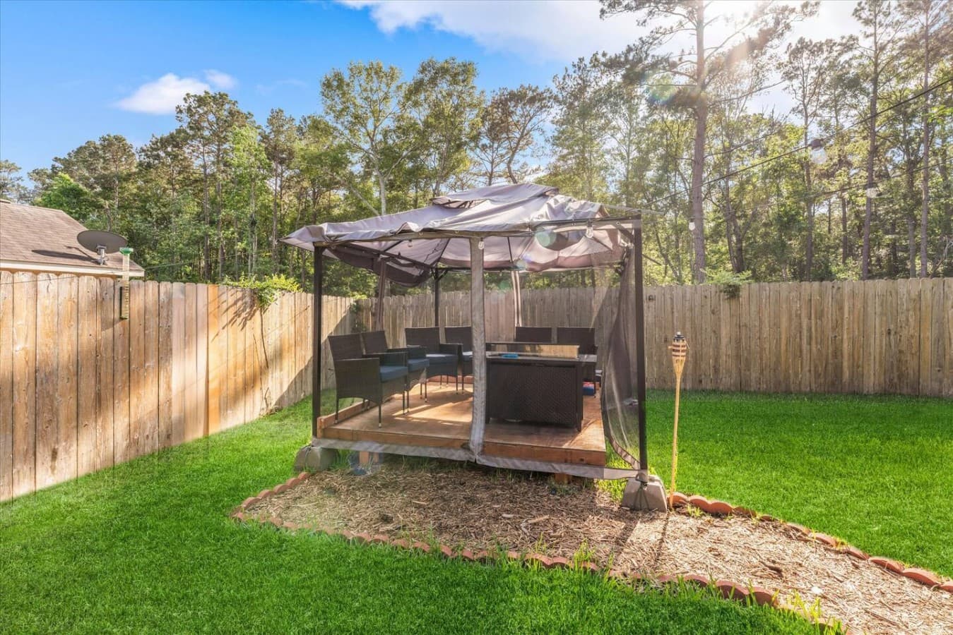 Private backyard gazebo offering a shaded space to unwind and enjoy the outdoors.