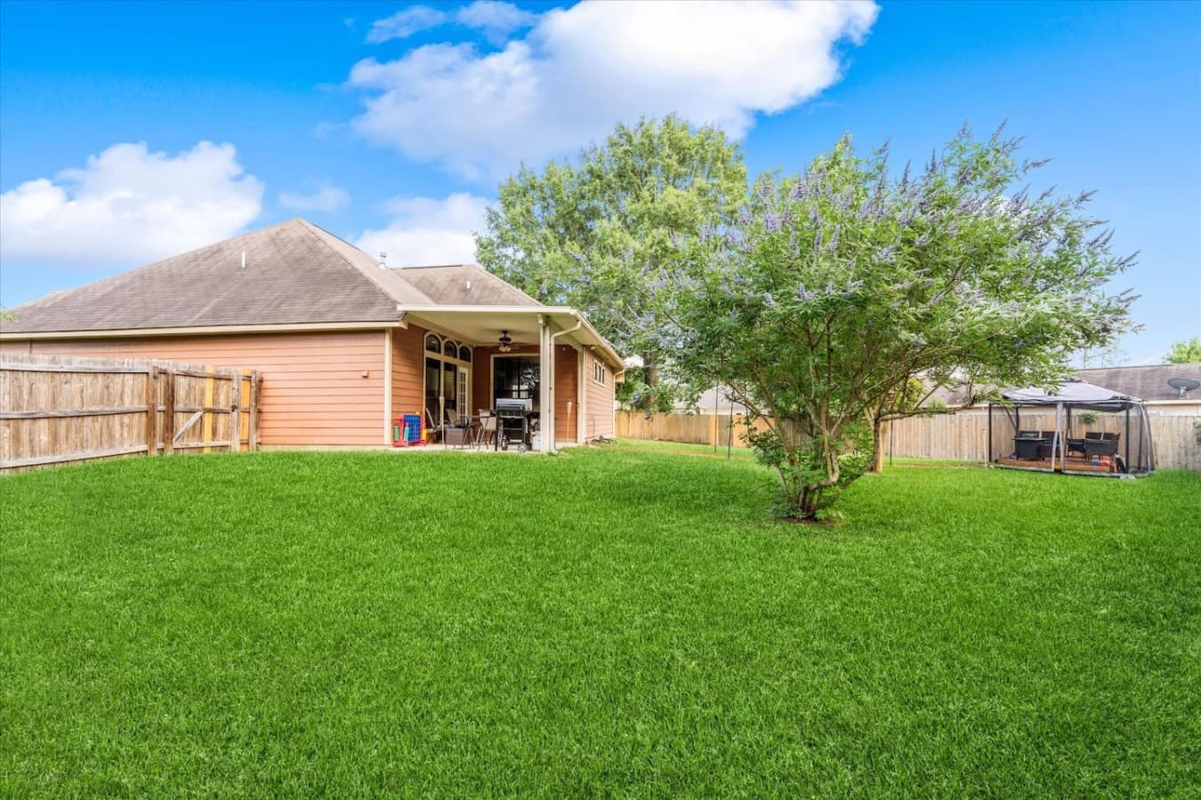 Expansive backyard with plenty of green space for relaxing, playing, and enjoying the outdoors.