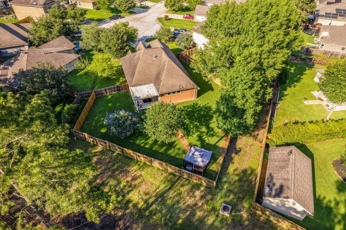 Aerial view showcasing the spacious property layout and fully fenced yard.