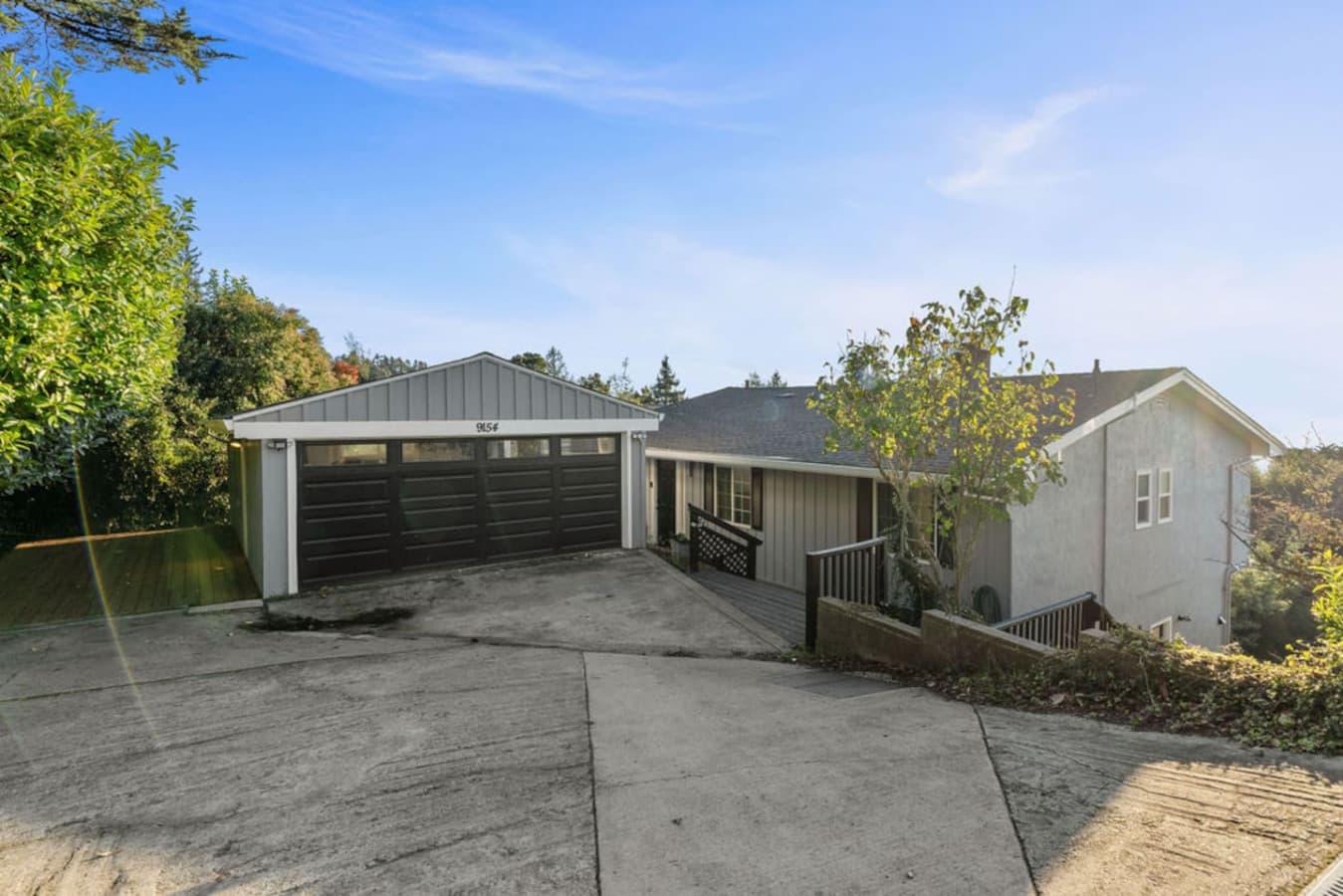 Exterior view of the home with a wide driveway and convenient parking space.