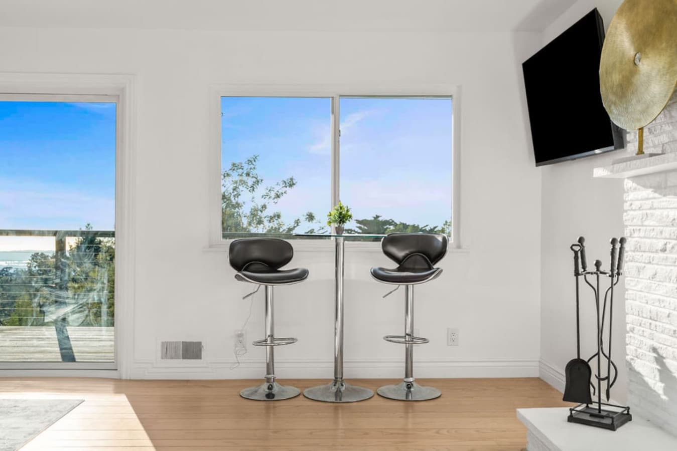 Simple window nook with bar stools offering a quiet spot to enjoy the view.