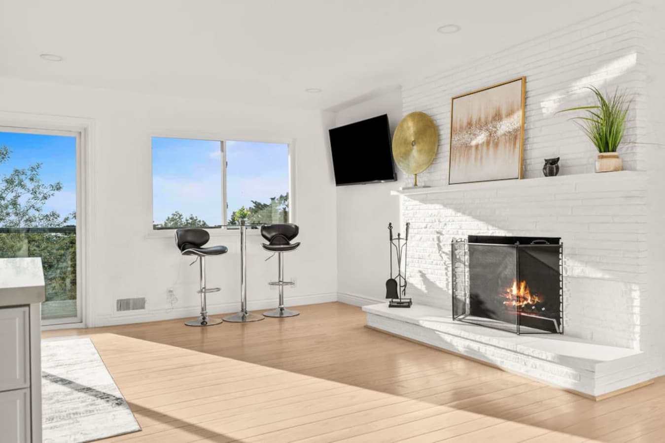 Warm and inviting corner with a fireplace and bar stools creating a perfect place to unwind.