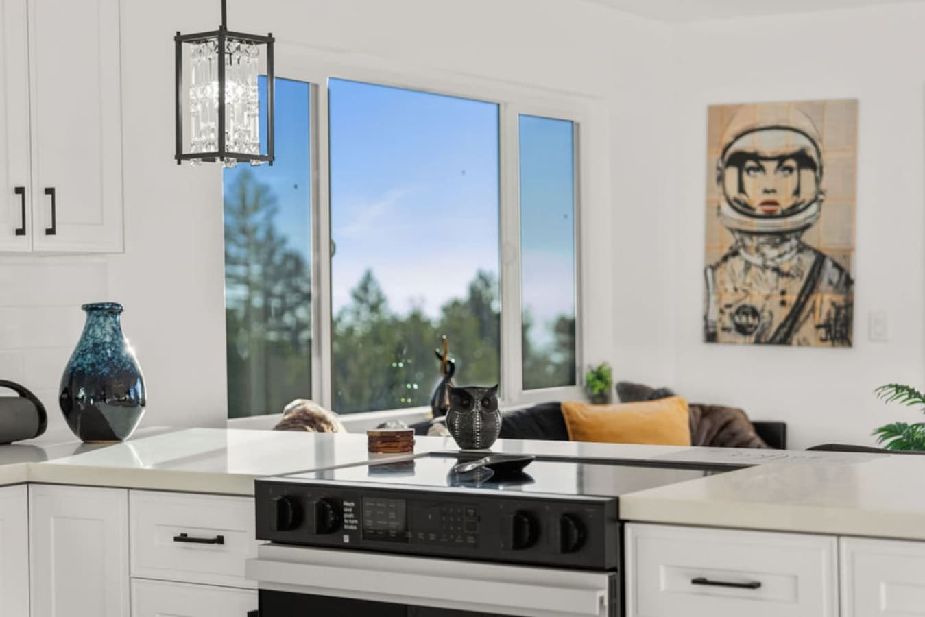 Kitchen island view with natural light and a cozy seating area nearby.