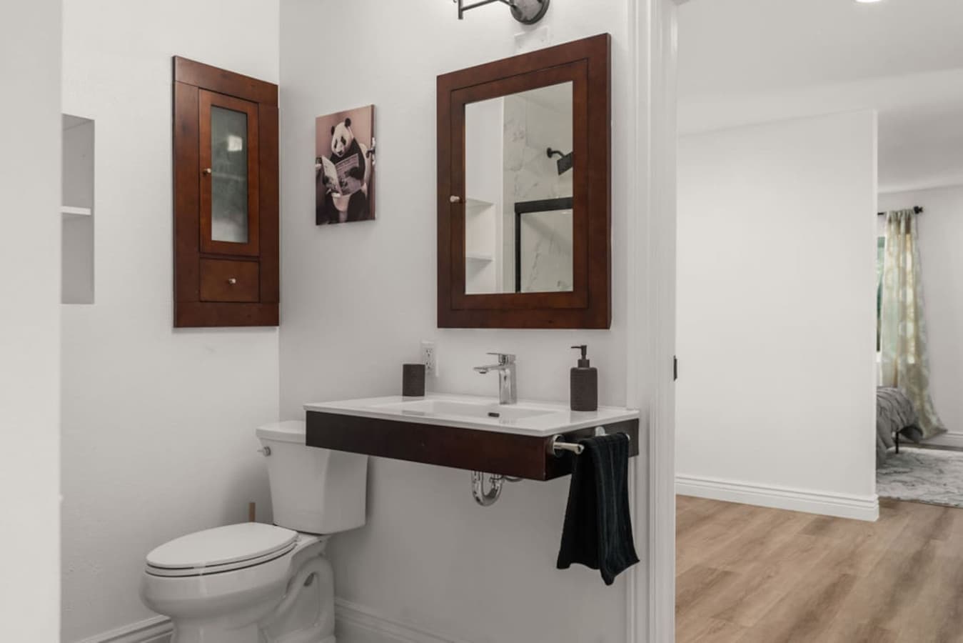 Clean and modern bathroom with a spacious vanity and warm wood accents.