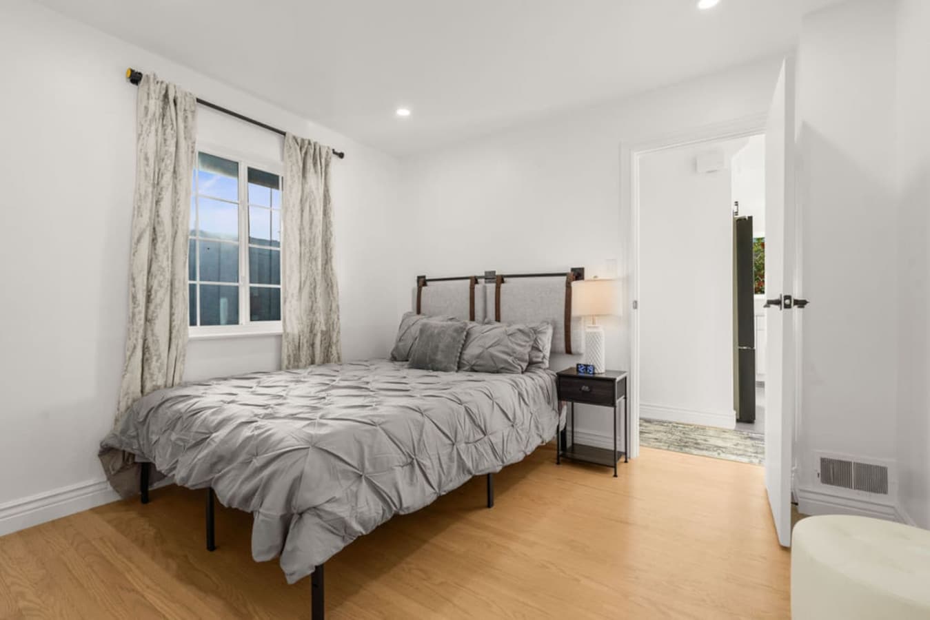 Cozy bedroom with soft bedding and warm lighting offering a comfortable place to unwind.