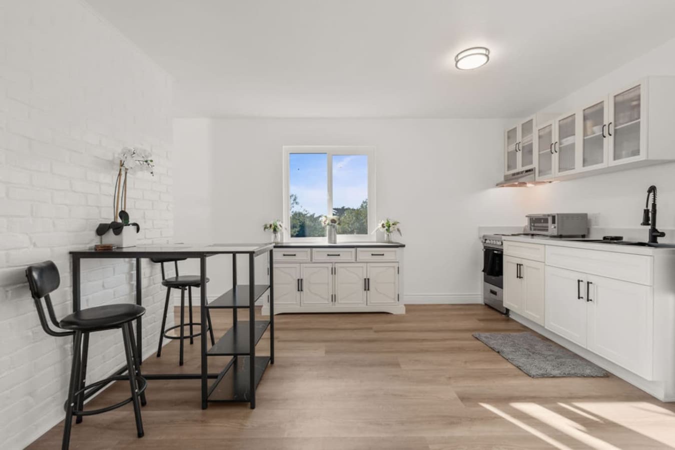 Spacious view of the Private In Law Suite kitchen featuring a dining area and plenty of room to prepare meals.