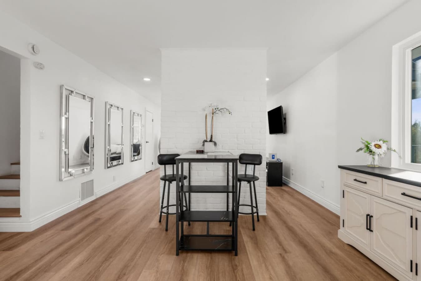 Dining area in the Private In Law Suite featuring a modern table and seating in a bright open layout.