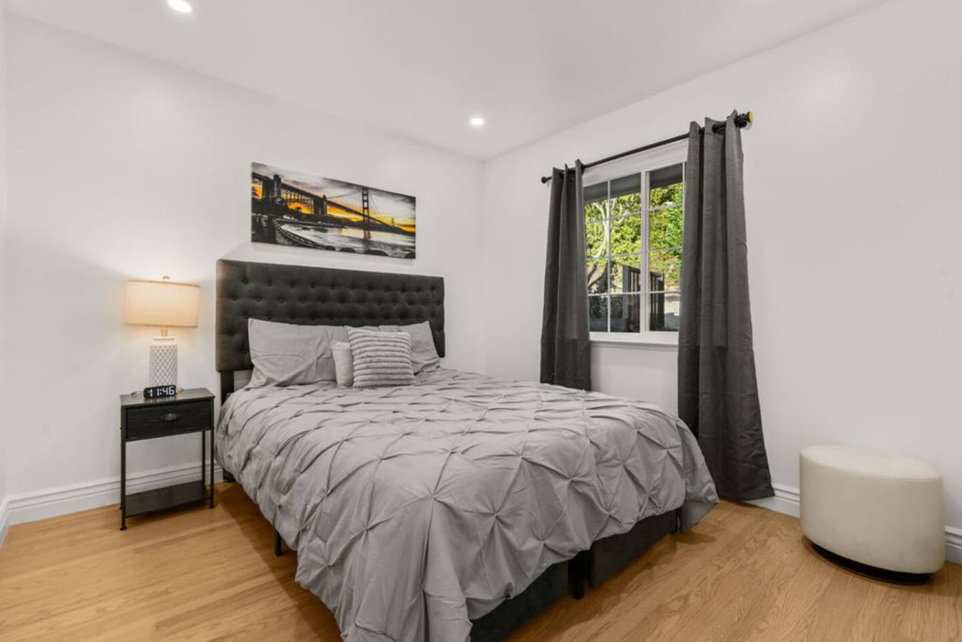 Cozy bedroom in the Private In Law Suite featuring a comfortable bed, warm lighting, and a peaceful window view.