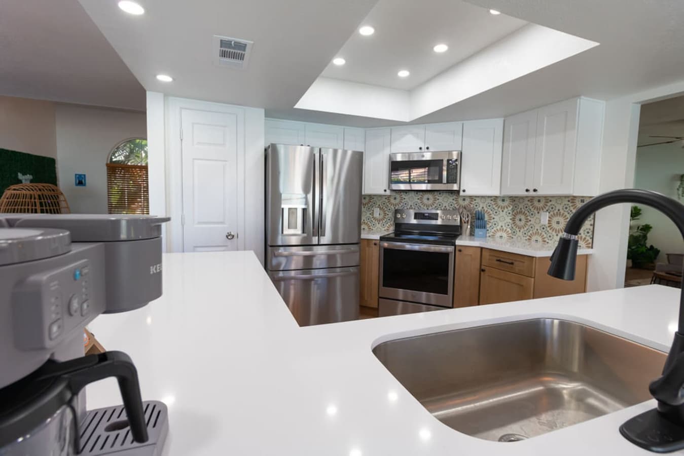 Fully equipped kitchen with stainless steel appliances and generous counter space.
