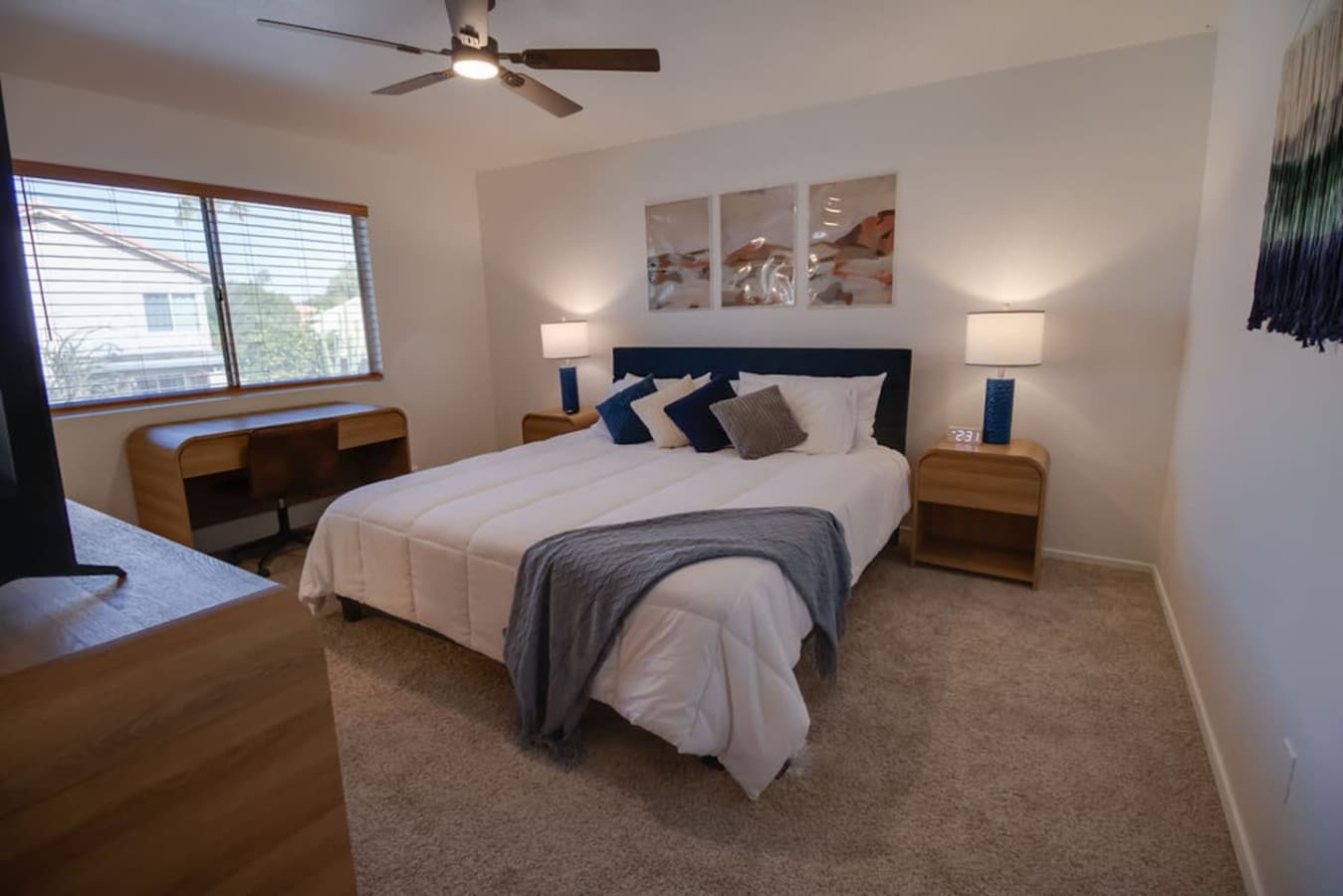 Spacious bedroom with a king bed and cozy layered bedding.