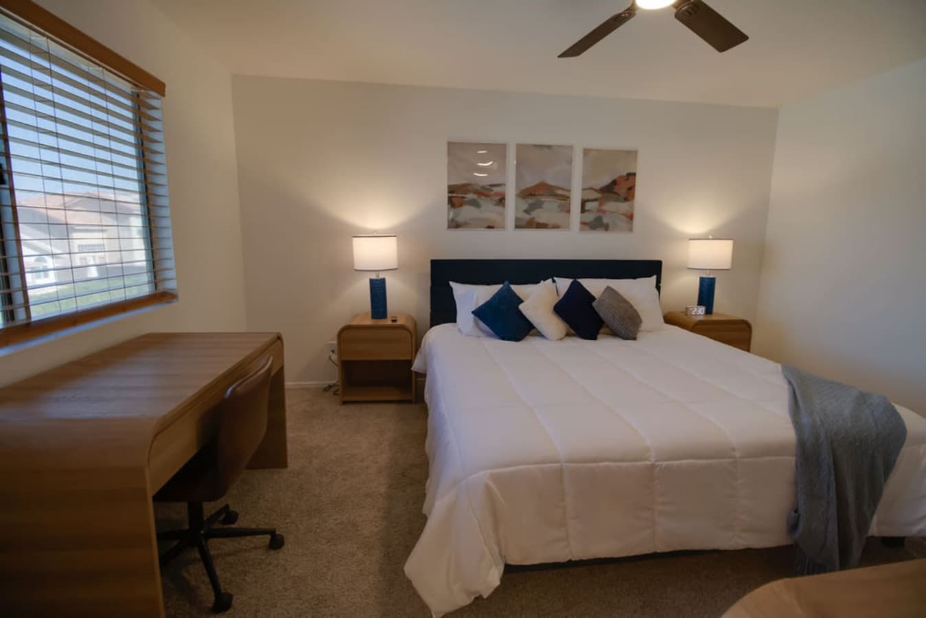 Comfortable bedroom setup with dedicated workspace.