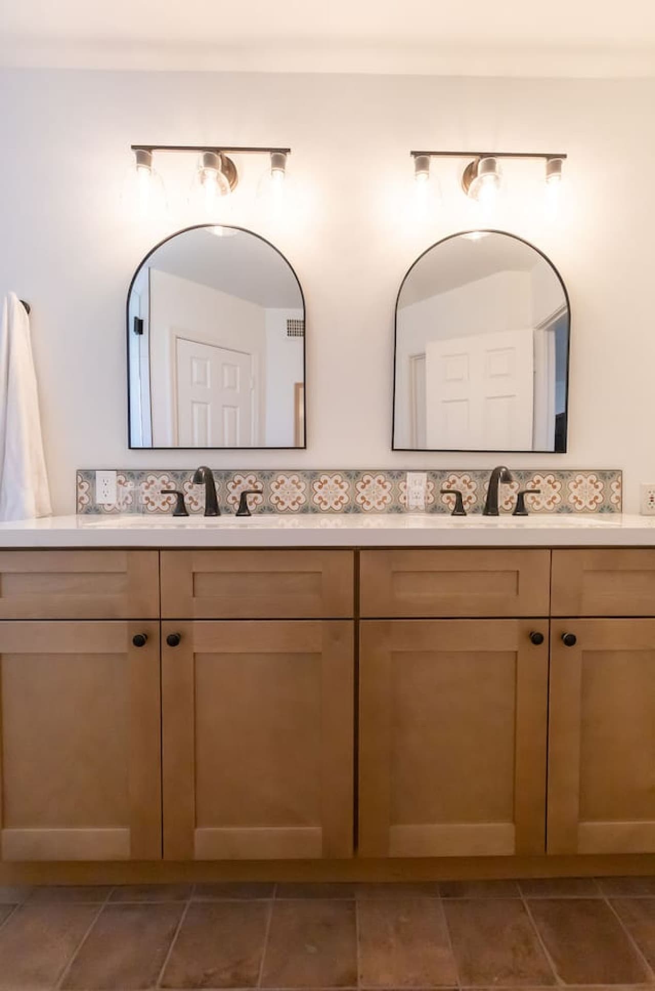 Double vanity bathroom with modern fixtures and ample storage.