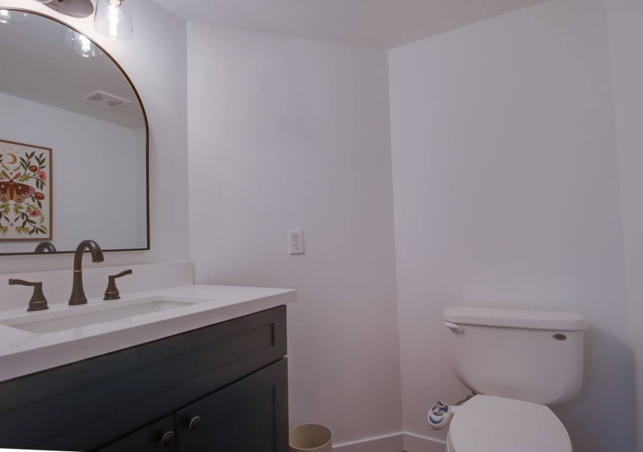 Additional bathroom with modern finishes and simple layout.