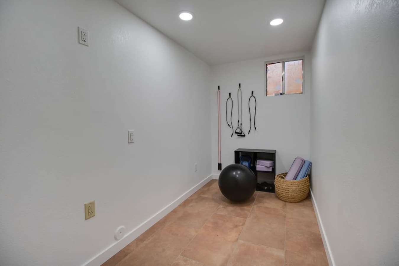 Bonus fitness room ideal for workouts stretching or storage.
