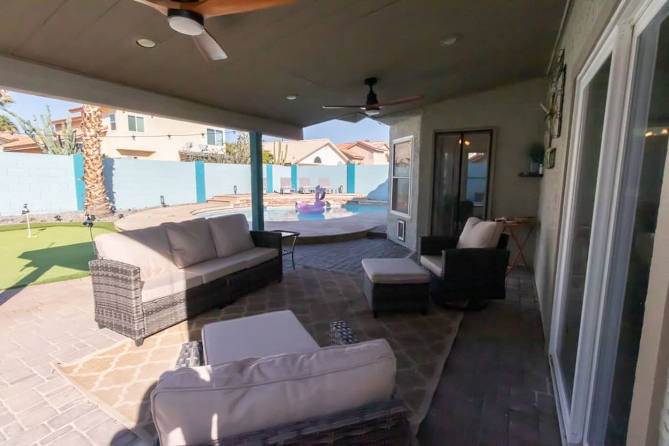 Covered patio with comfortable outdoor seating.