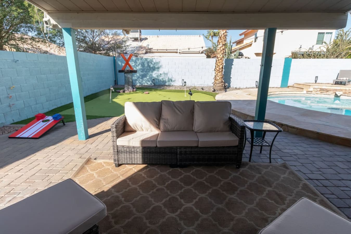 Shaded outdoor lounge overlooking the yard and games area.