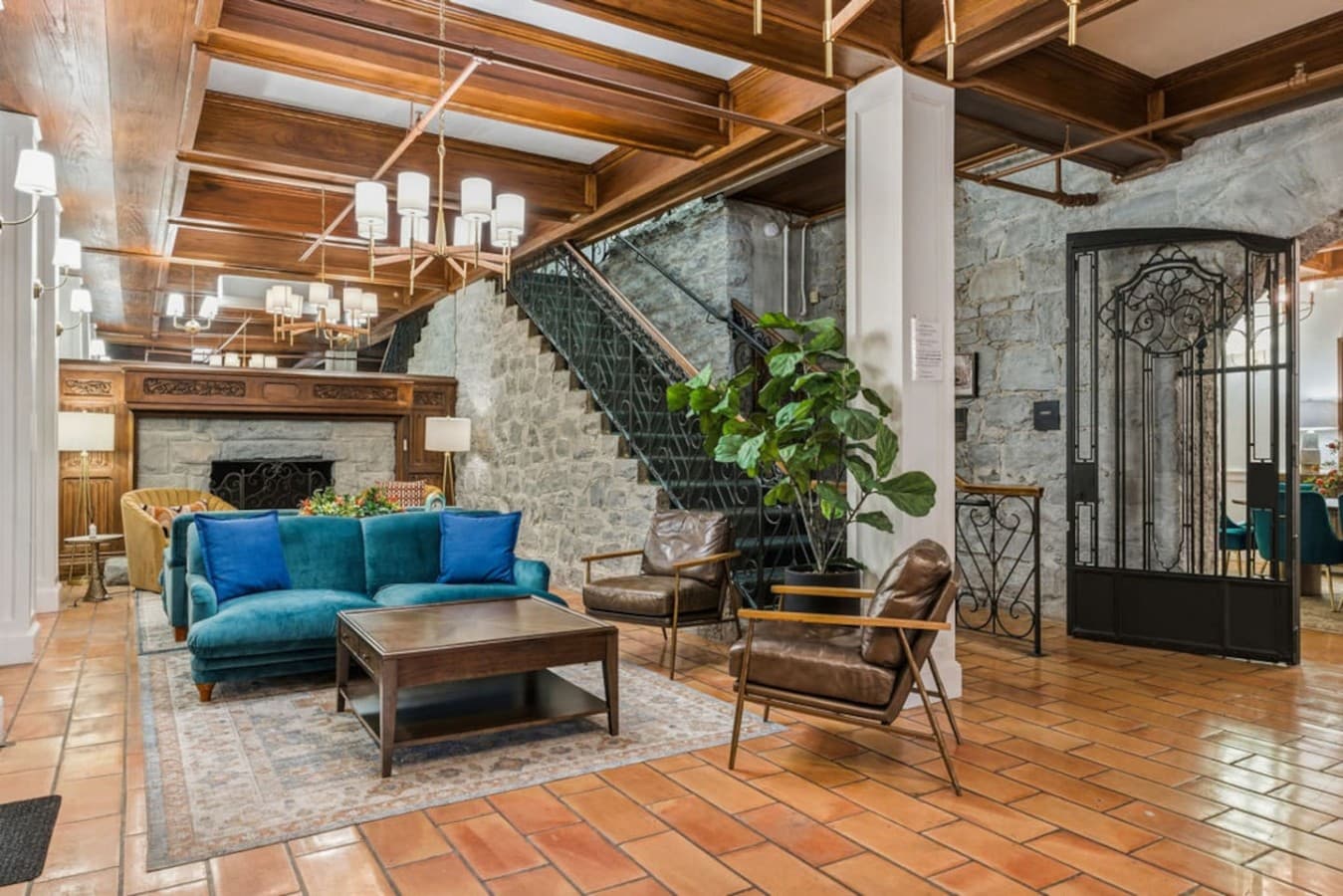 A spacious shared gathering room with plush seating and rustic stone accents creating a warm and inviting atmosphere.