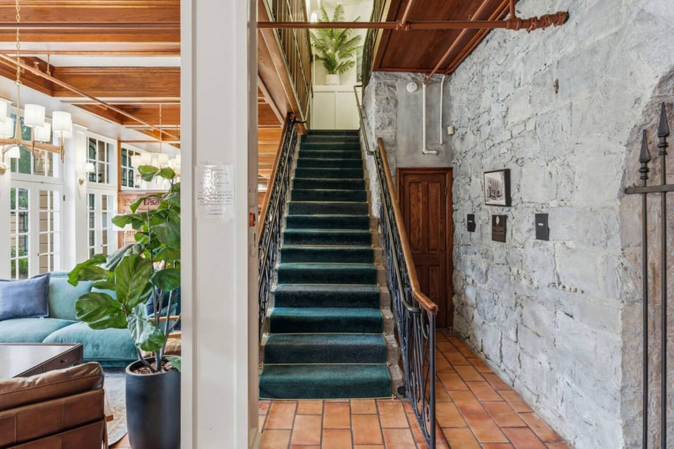 A beautifully maintained shared stairway with stone walls and classic architectural details offering a warm and historic welcome.