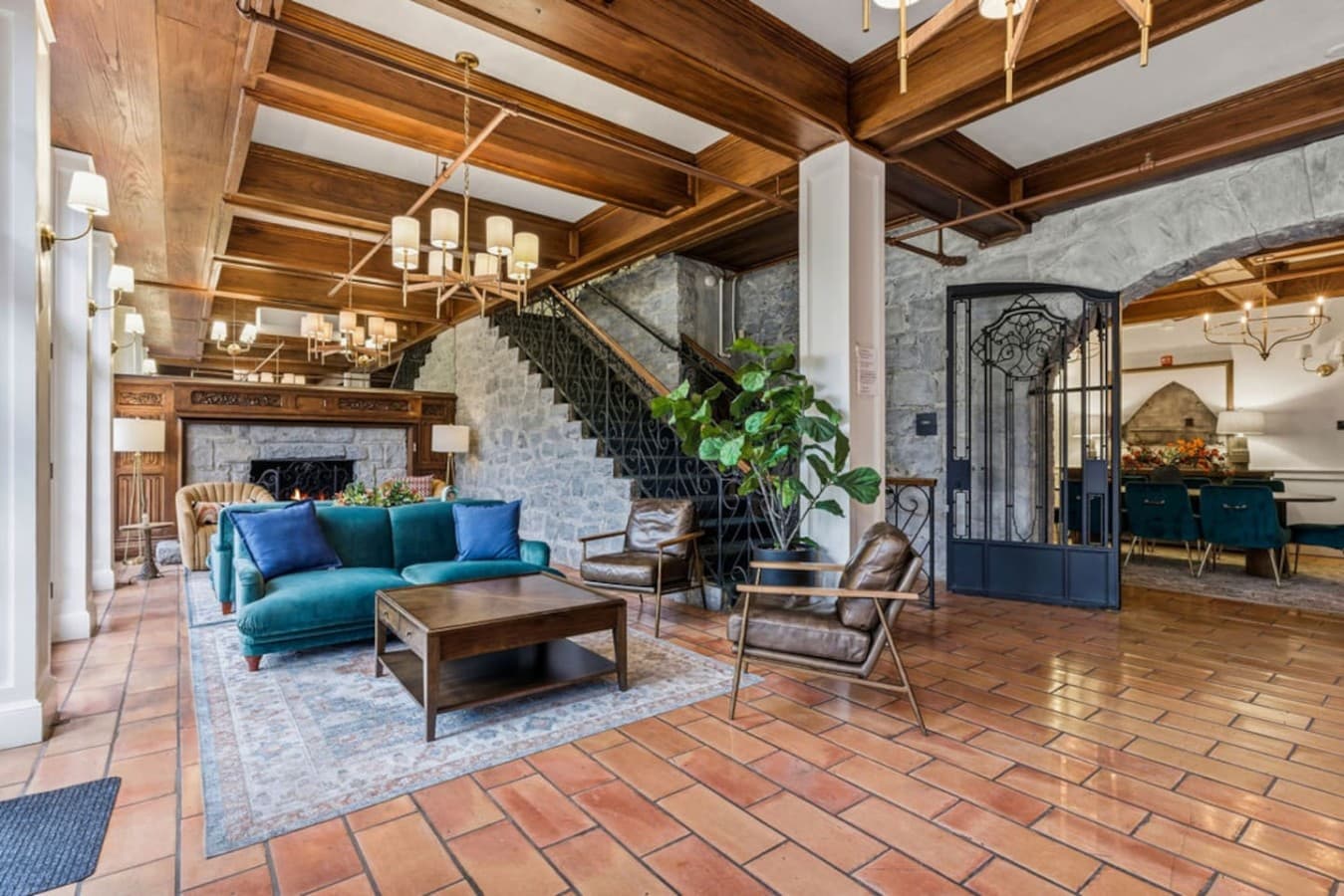 A spacious shared lounge featuring stylish seating, natural textures, and an inviting atmosphere for guests to relax.