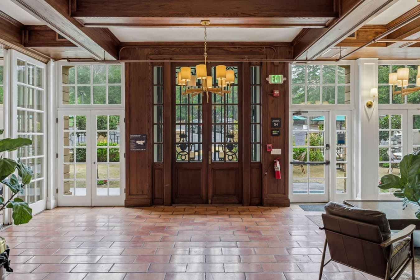 A grand shared entryway with elegant wood details and expansive windows offering a beautiful first impression.
