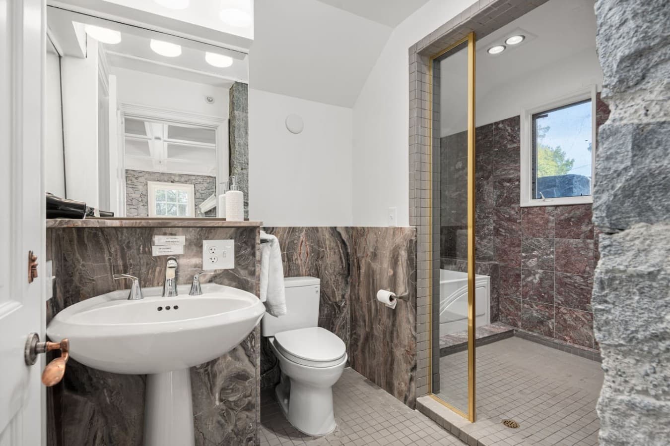 This is the private bathroom inside the room you will be renting featuring a walk-in shower and bright, clean finishes.
