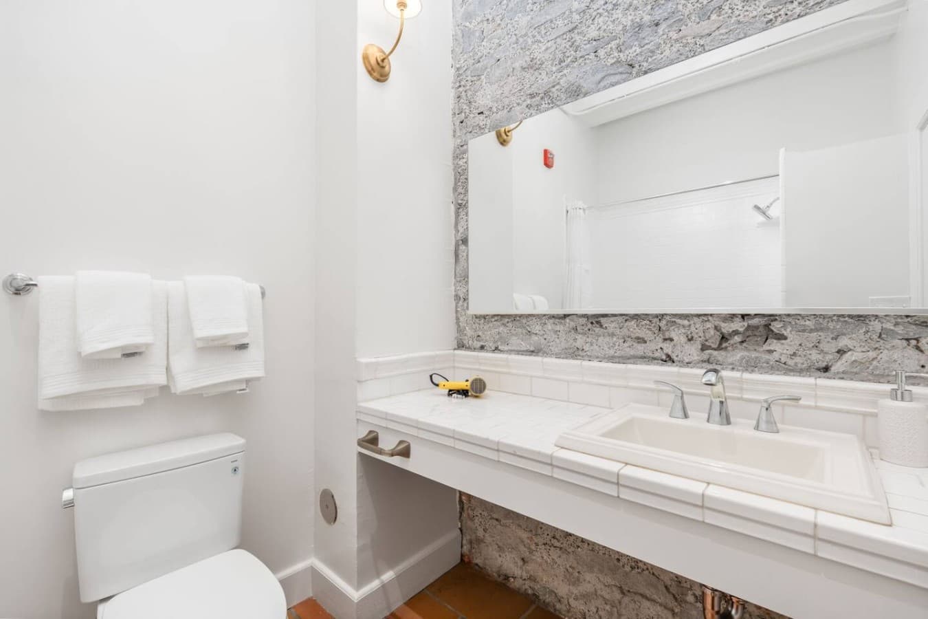 A private bathroom with a spacious vanity, bright lighting, and fresh towels provided.