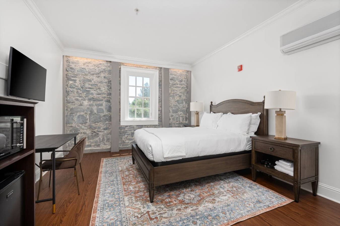 This is the private room you will be renting featuring a cozy queen bed, stone-accented walls, and a warm inviting layout.