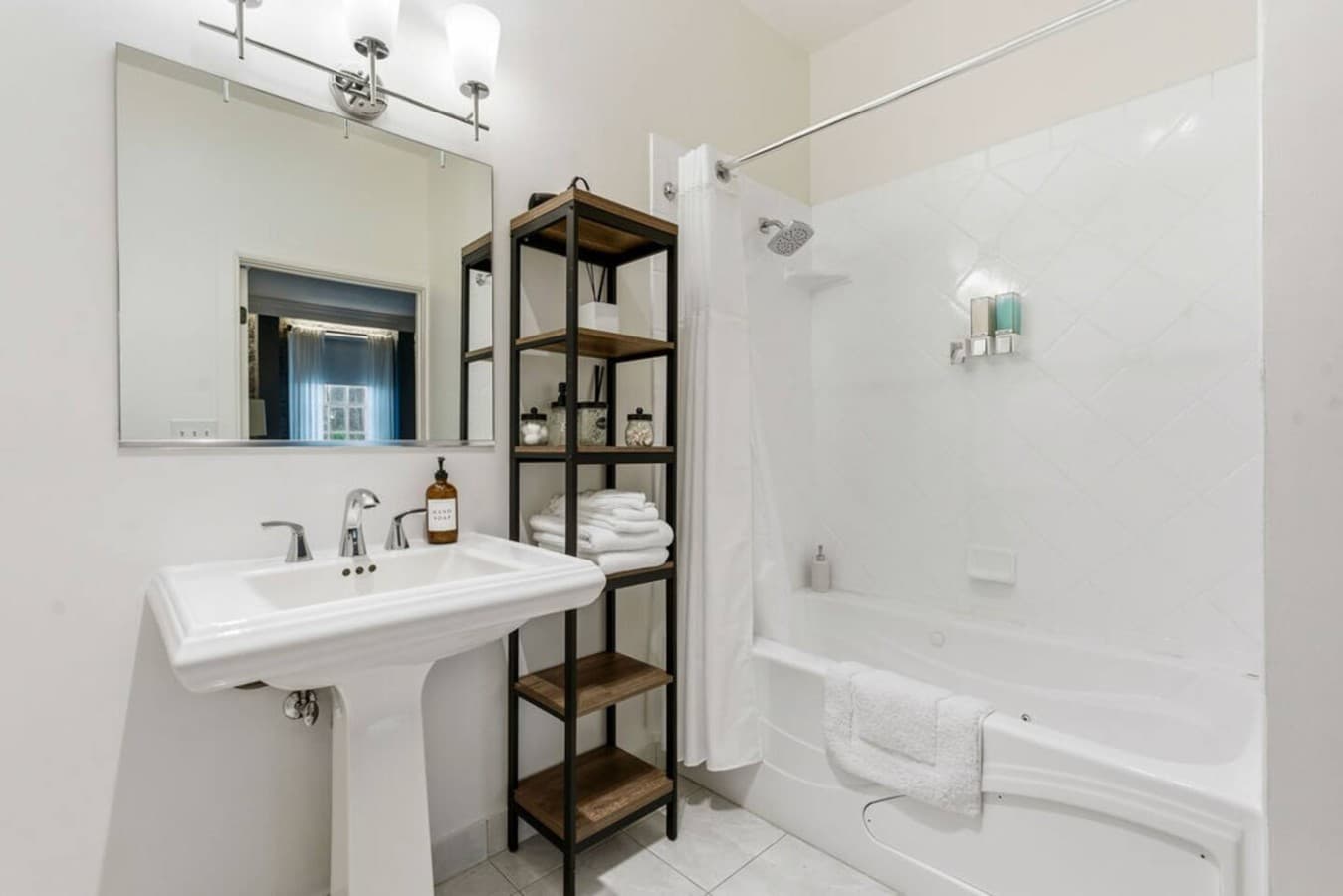 This is the private bathroom inside the room you will be renting featuring a clean shower and tub combination with bright, simple finishes.