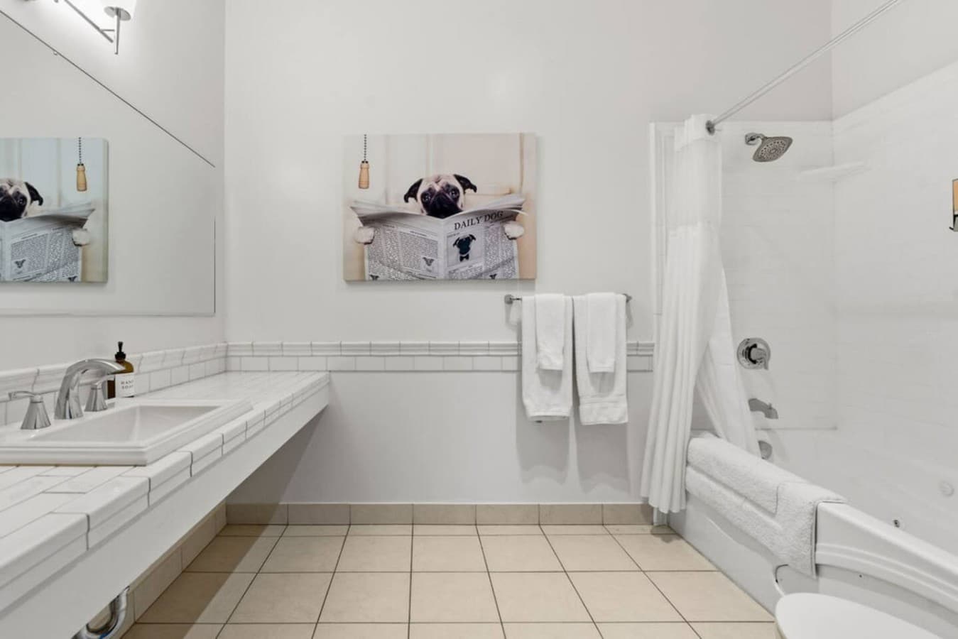his is the private bathroom inside the room you will be renting featuring a clean shower and tub combination with bright, simple finishes.