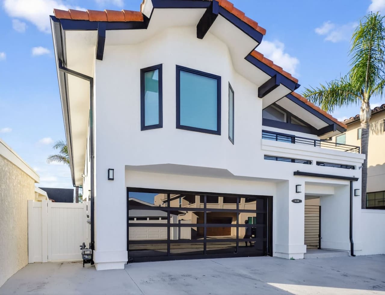 Modern coastal exterior with private garage and clean architectural design.