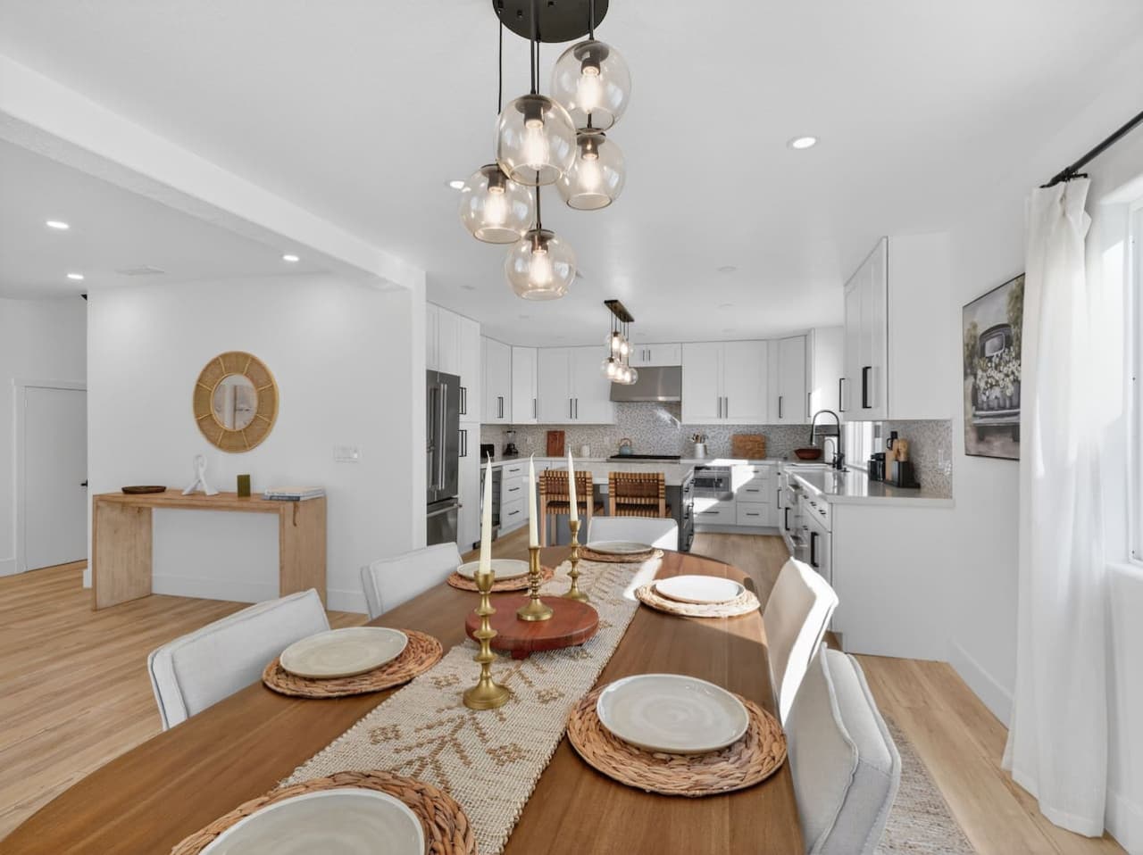 Open concept kitchen flowing into dining and living spaces.