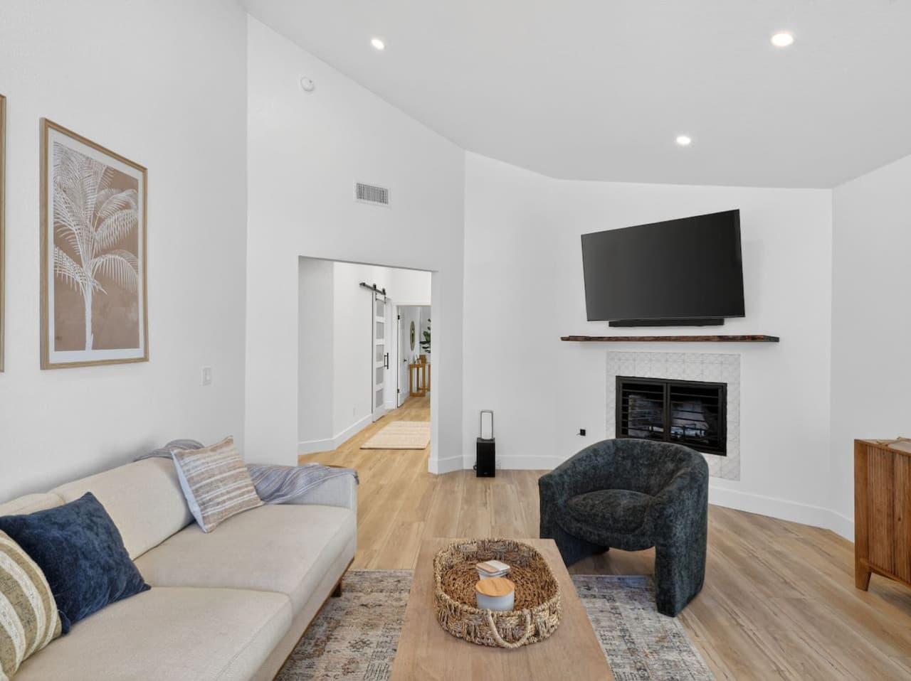 Comfortable living room with vaulted ceilings and natural light.