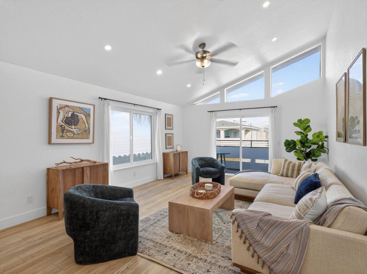 Bright living space with vaulted ceilings and abundant natural light.