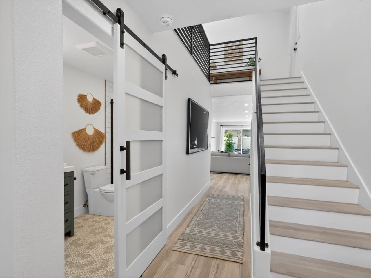Entry hallway with staircase and stylish sliding barn door detail.