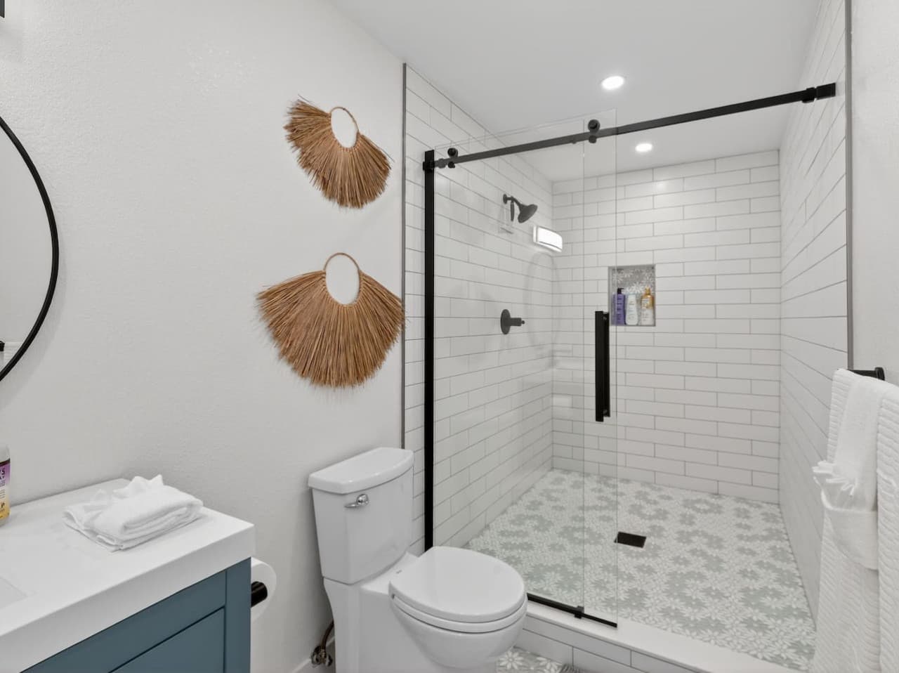 Walk in shower with sleek tile and contemporary fixtures.