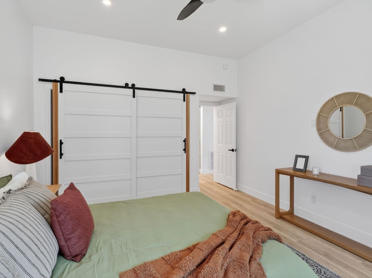 Stylish bedroom with sliding barn doors and calming tones.