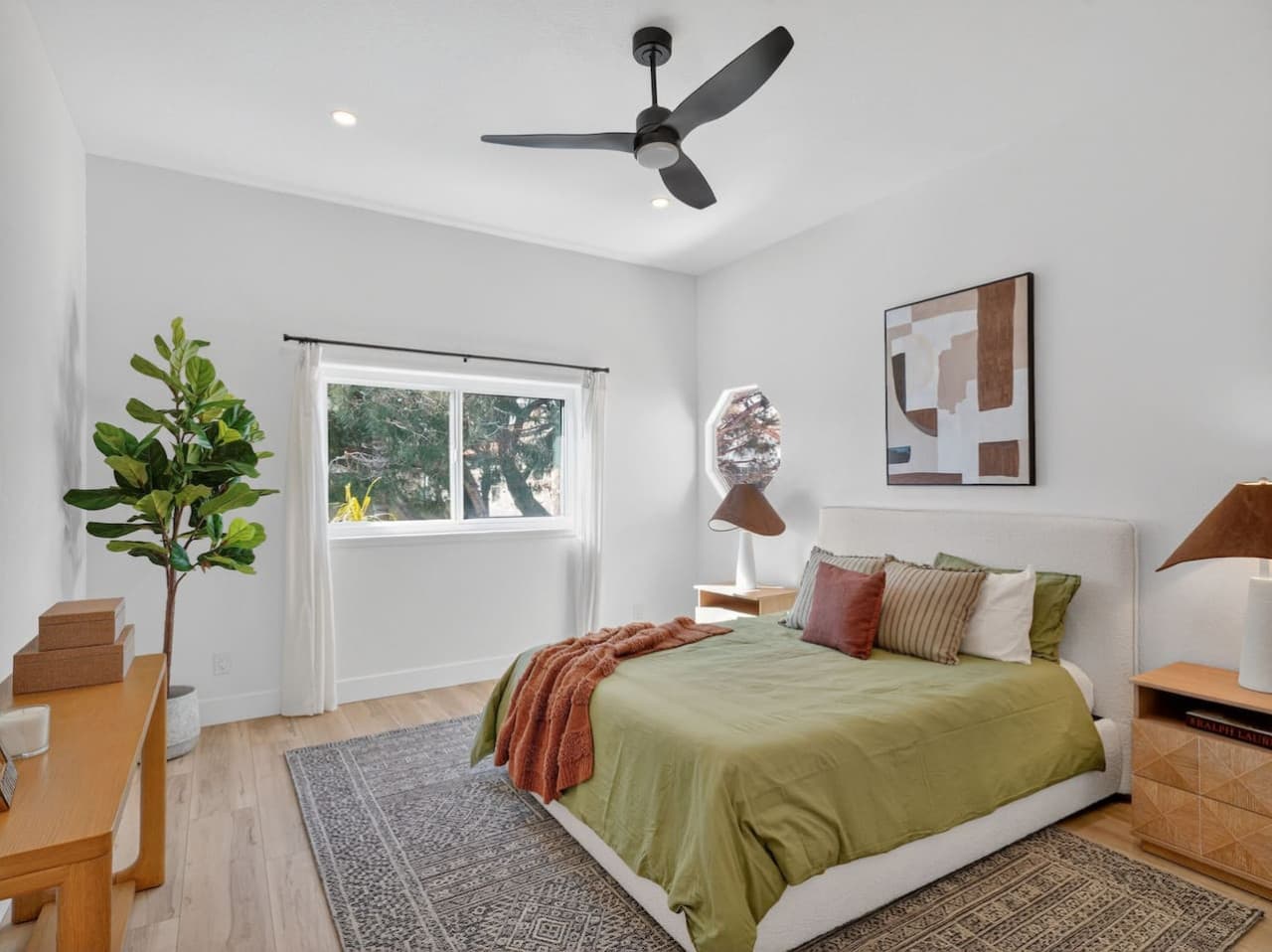 Peaceful bedroom with soft linens and natural light.