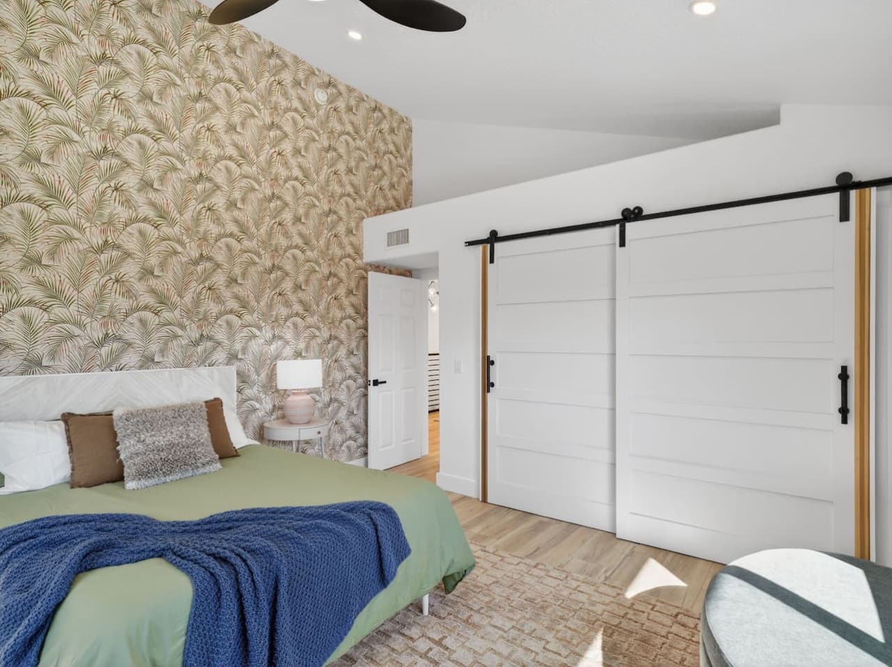 Designer bedroom with accent wall and modern finishes.