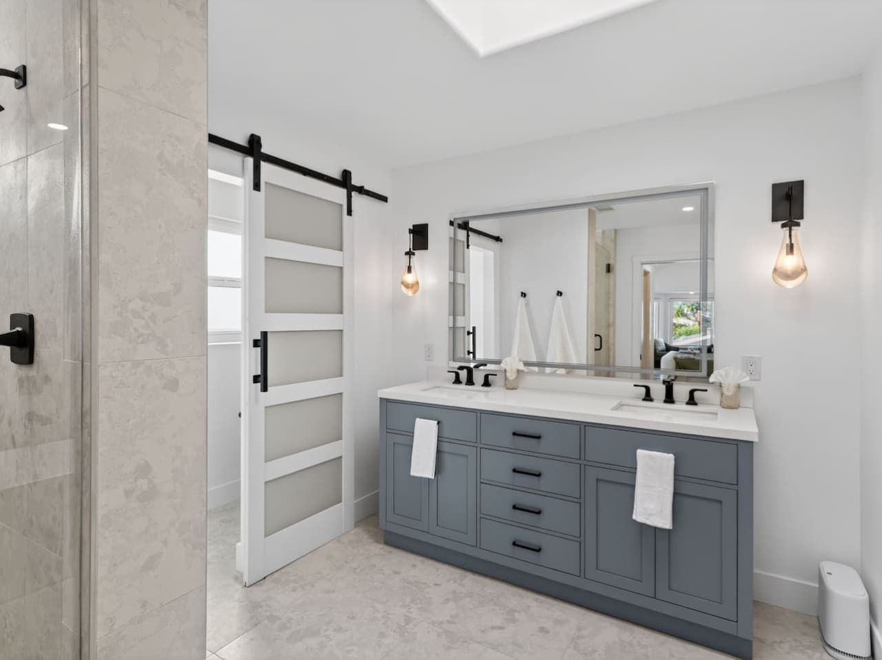 Modern bathroom with dual vanity and ample counter space.