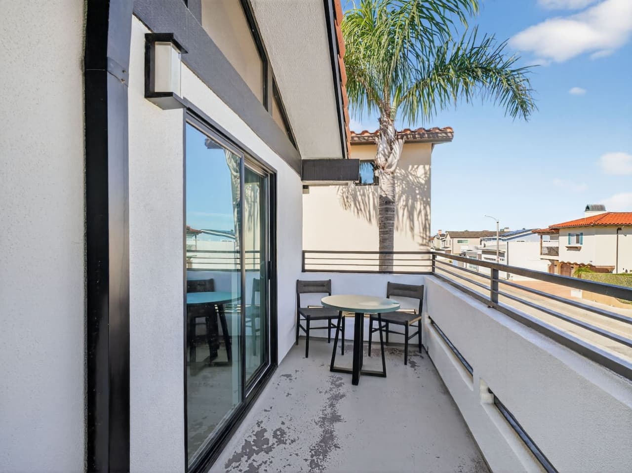 Private balcony with outdoor seating and fresh air.