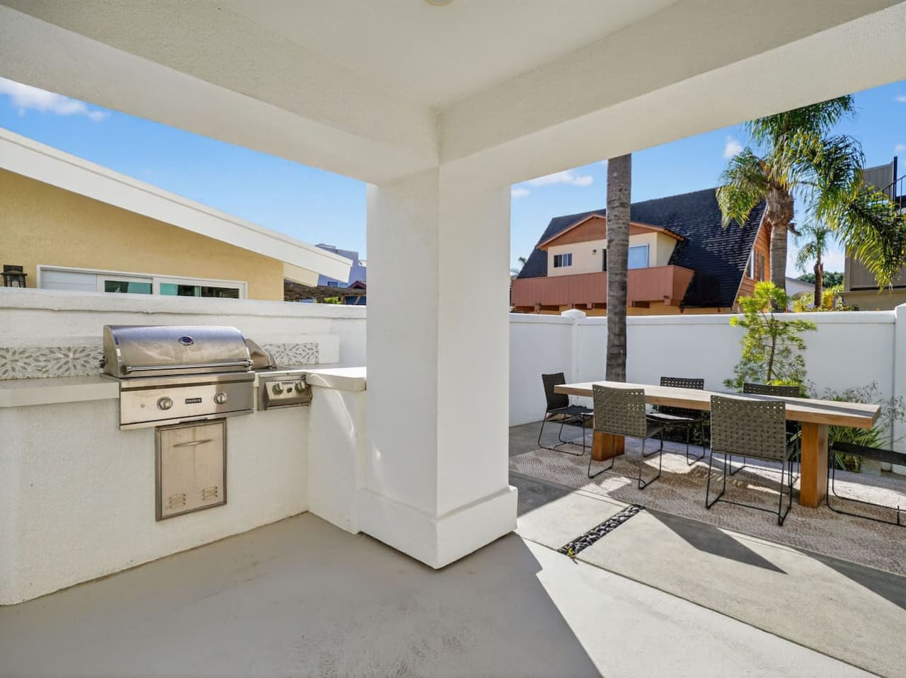 Covered outdoor grilling area perfect for dining al fresco.