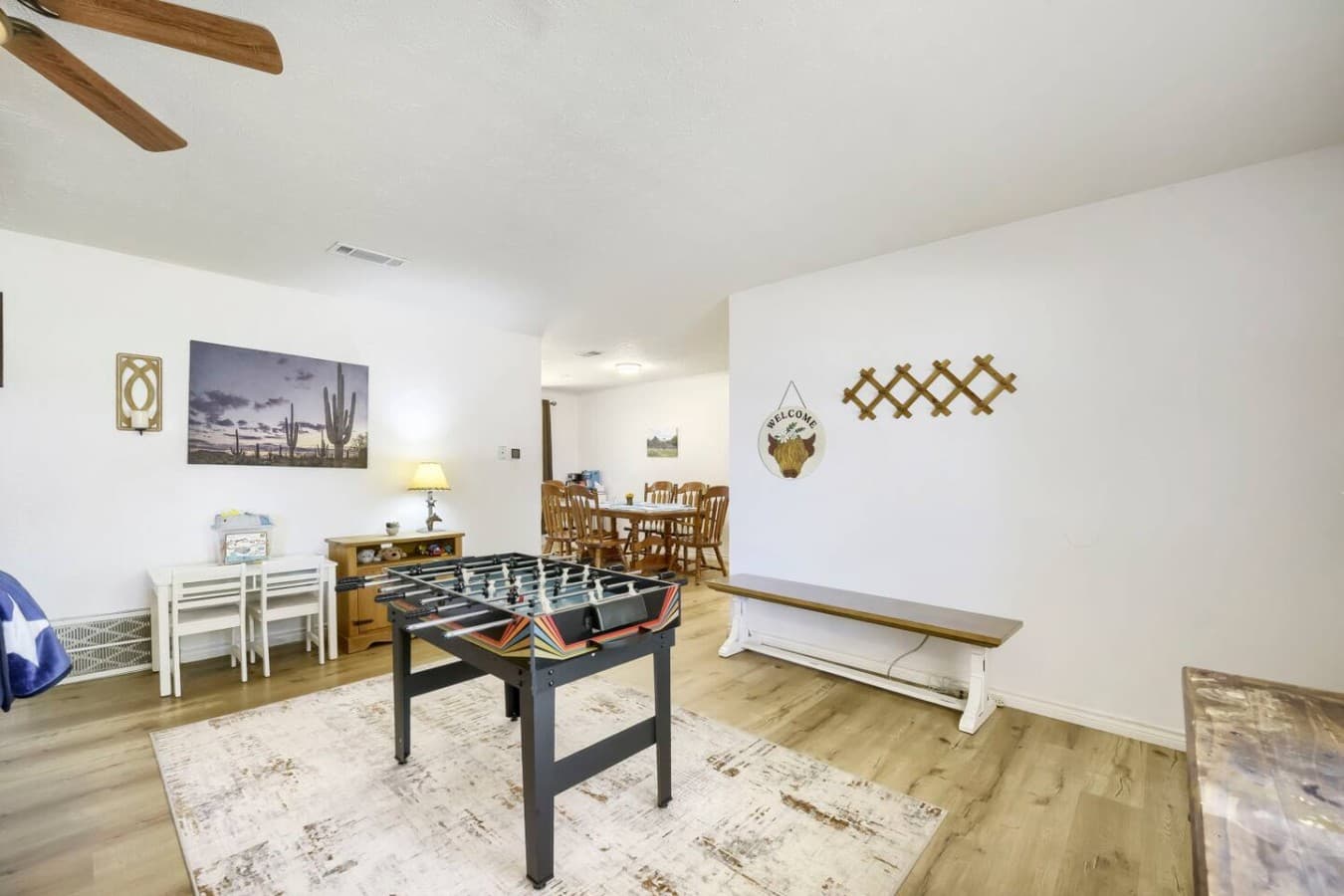 Fun game room area with foosball table and open dining space for gathering.