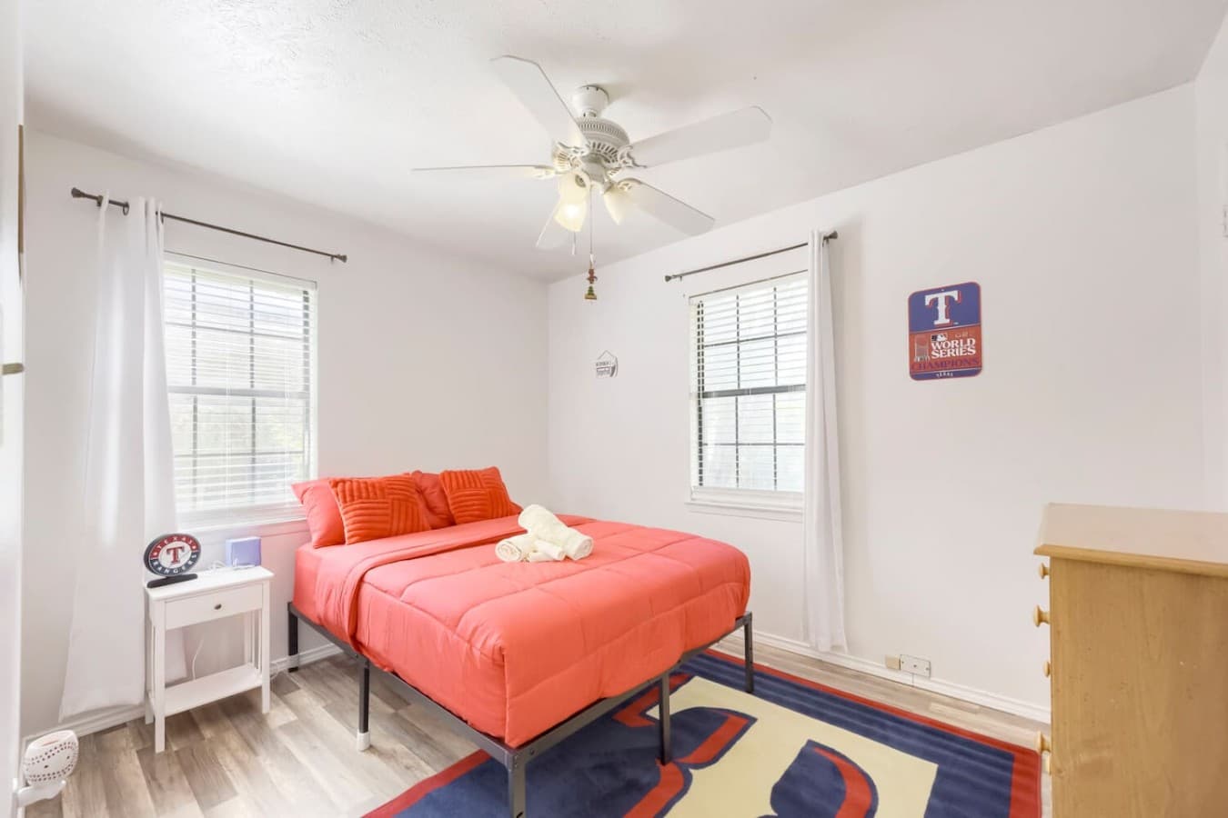 Cheerful bedroom with vibrant accents and plenty of natural light throughout.