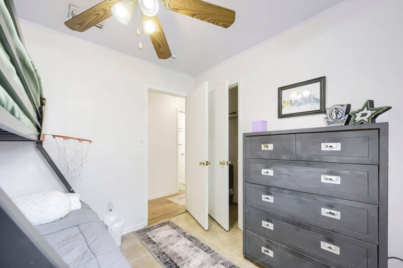 Spacious bedroom with dresser storage and bright relaxing atmosphere.